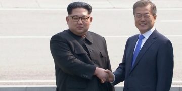 Smiling and holding hands, leaders of two Koreas meet at historic summit