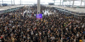 Hong Kong airport grinds to halt as China likens protests to terrorism