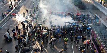 Police battle protesters as strike paralyses Hong Kong