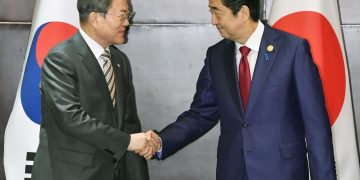 Japan’s Abe asks South Korea’s Moon to act on row at first meeting for 15 months