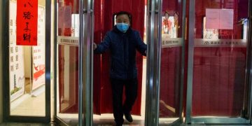 China seeks to boost economy as first virus death reported outside its borders