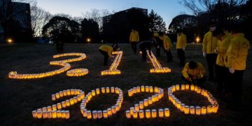 With sadness but no ceremony, Japan marks disaster anniversary