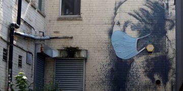 Banksy’s ‘Girl with a Pierced Eardrum’ gains a coronavirus face mask