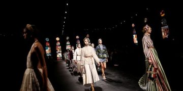 With masked guests, Dior returns to catwalk in Paris
