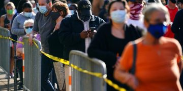 Anxious Americans vote on Election Day with faces masked, stores boarded up