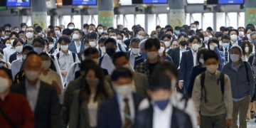 Packed trains, drinking: Japanese impatient over virus steps