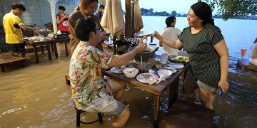 At flooded restaurant near Bangkok, the special is a splash