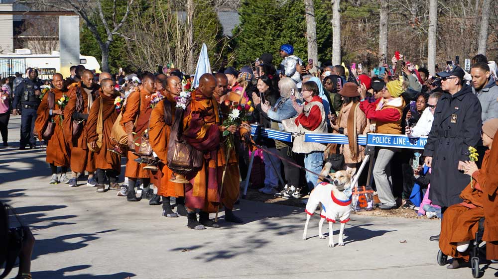 Maha Ajarn Dam Phommasan welcoming the Walk for Peace monks as they arrived at Wat Buddha Khanti with Aloka the Dog in December 2025. Photo: Georgia Asian Times