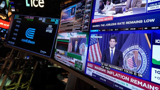 US stocks slip after the Fed hikes interest rates and hints more increases may be on the way