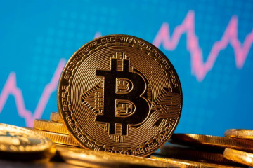 FILE PHOTO: A representation of virtual currency Bitcoin is seen in front of a stock graph in this illustration taken November 19, 2020. REUTERS/Dado Ruvic/Illustration/File Photo