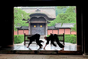 FILE - Monks polish the wooden corridor of the walkway that connects between temple buildings at Soji-ji in Yokohama, Japan on July 5, 2016. (AP Photo/Kiichiro Sato, File)