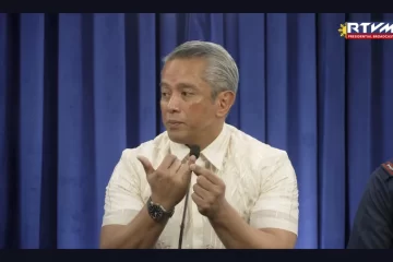 This image made from video provided by RTVM, Filipino Interior Secretary Jonvic Remulla points to a finger when referring to which finger of the Chinese student was cut off after being kidnapped by a Chinese-led gang, in at a press briefing in Manila, Wednesday, Feb. 26, 2025. (RTVM via AP)